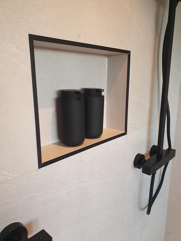 A recessed shelf tiled into the shower wall